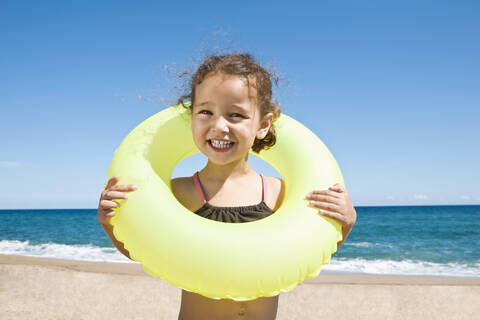 France, Corsica, Girl (2-3) wearing inner tube, smiling, portrait stock photo