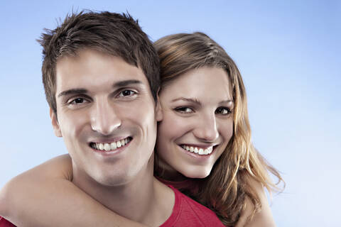 Woman embracing man, smiling, portrait stock photo