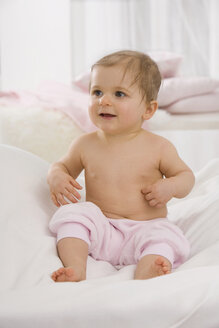 Baby girl (6-11 months) smiling, looking away - SMOF00435
