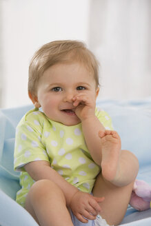 Baby girl (6-11 months) finger in mouth, portrait - SMOF00426