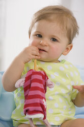 Baby girl (6-11 months) playing with toy, portrait - SMOF00425