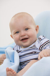 Baby boy (6-11 months) smiling, portrait - SMOF00419