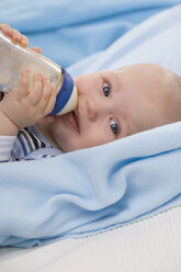 Baby boy (6-11 months) drinking milk, smiling, portrait - SMOF00410