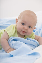 Baby boy (6-11 months) lying, smiling, portrait - SMOF00406