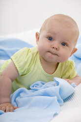 Baby boy (6-11 months) lying, smiling, portrait - SMOF00405