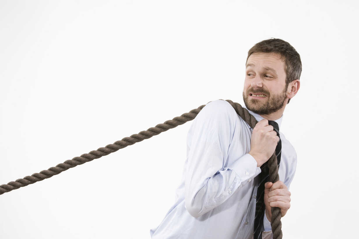 Businessman Pulling Rope On White Stock Photo, Picture and Royalty