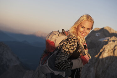 Portrait of happy young woman hiking in the mountains stock photo