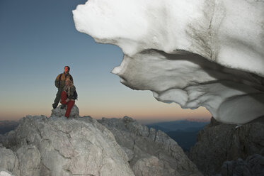 Österreich, Steiermark, Dachstein, Junges Paar rastet auf Berggipfel - HHF03325