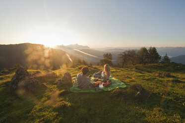 Young couple lying on blanket, looking at view. - HHF03211