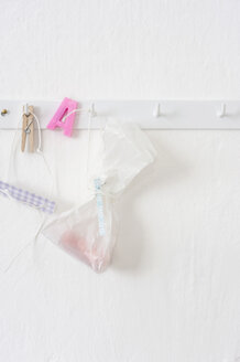 Pastries in plastic bags hanging on hook rack - COF00141