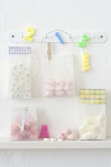 Pastries in plastic bags hanging on hook rack - COF00138