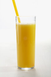 Glass of orange juice with straw on white background - CHKF01050