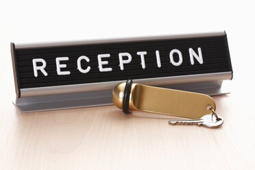 Reception sign with hotel key on desk - 12667CS-U