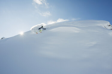 Austria, Man skiing on snow covered arlberg mountain - MIRF00053
