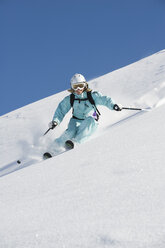 Austria, Woman skiing on arlberg mountain, smiling - MIRF00050