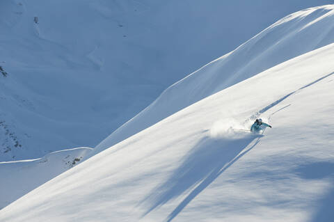 Austria, Woman skiing on snow covered arlberg mountain stock photo