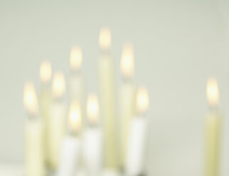 Burning candles on white background, soft focus - SRSF00075