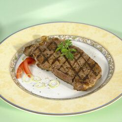 Pork steak on plate, close-up - SRSF00054