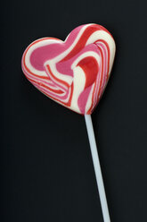 Pink heart shaped lollipop on black background - AWDF00538