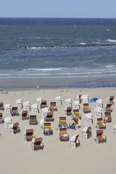 Germany, Ruegen Island, Baltic Sea, Tourist resting in Hooded chair on beach - RUEF00380