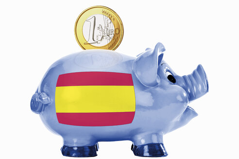 Piggy bank with 1 euro coin and spanish flag stock photo