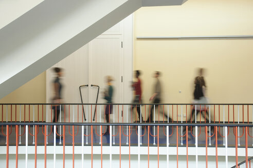 Germany, Leipzig, Group of university students walking through corridor (blurred motion) - BABF00622