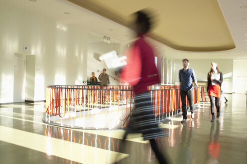 Germany, Leipzig, University students walking through corridor (blurred motion) - BABF00621