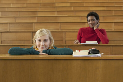 Germany, Leipzig, Students sitting in auditorium, smiling, portrait - BABF00582