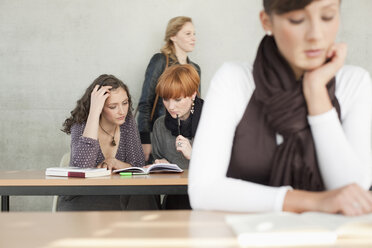 Germany, Leipzig, University students studying together in classroom - BABF00547