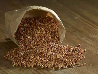 Buckwheat grains spilling on wooden surfae - SRSF00180