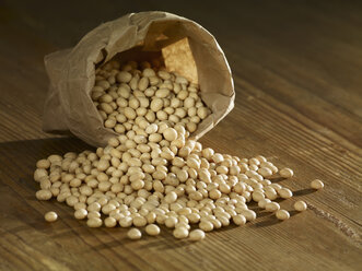 Pea beans spilled on wooden surface - SRSF00153