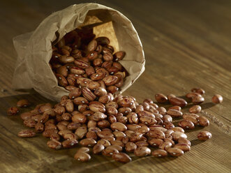 Pinto beans spilled on wooden surface - SRSF00152