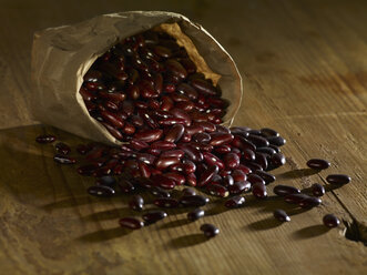 Kidney beans spilled on wooden surface - SRSF00145