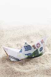 Origami paper boat of euro notes on sand - 13045CS-U