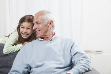 Granddaughter (6-7) and grandfather smiling - CLF00904