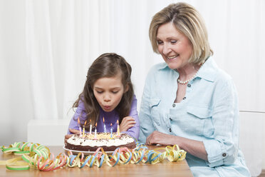 Granddaughter (6-7) and grandmother celebrating birthday - CLF00902