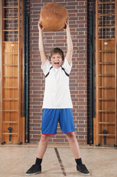 Germany, Emmering, Teenage boy (14-15) holding ball, portrait - WESTF14654