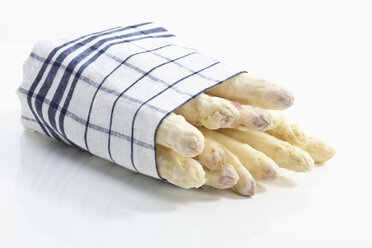 White asparagus wrapped in cloth on white background - MAEF02320