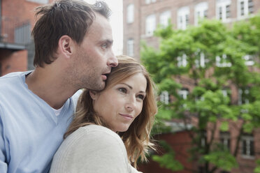 Germany, Couple relaxing on balcony, looking away - WESTF14884