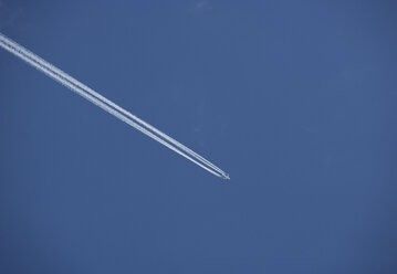 Austria, View of aeroplane flying in blue sky - WWF001379