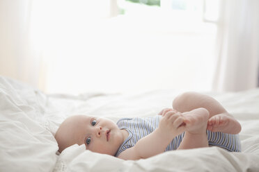 Deutschland, München, (2-5 Monate) Baby-Junge auf Bett, Portrait - RBF000257