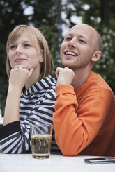 Germany, Berlin, Young man and woman looking away, smiling - WESTF015203