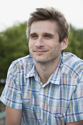 Germany, Berlin, Man looking away and smiling, close up - WESTF015194