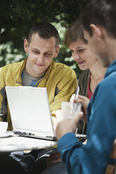 Germany, Berlin, Man and woman using laptop - WESTF015112