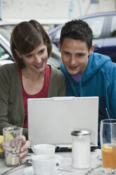 Germany, Berlin, Man and woman using laptop - WESTF015109