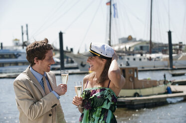 Germany, Hamburg, Couple drinking champagne, smiling - WESTF015247