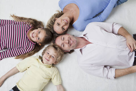 Overhead view of family smiling, portrait stock photo