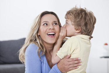 Son whispering into mother's ear - LDF000837