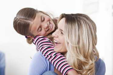 Mother and daughter playing and smiling - LDF000836