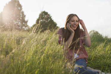 Germany, Berlin, Teenage girl using mobile phone - WESTF015310